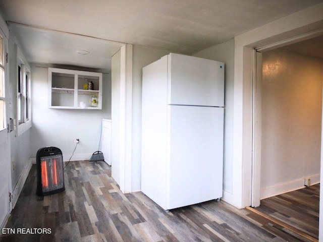 kitchen with dark hardwood / wood-style floors and white fridge