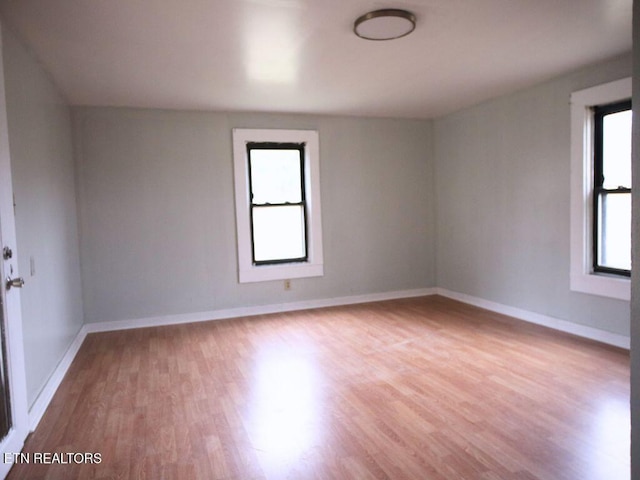 unfurnished room with plenty of natural light and light hardwood / wood-style floors