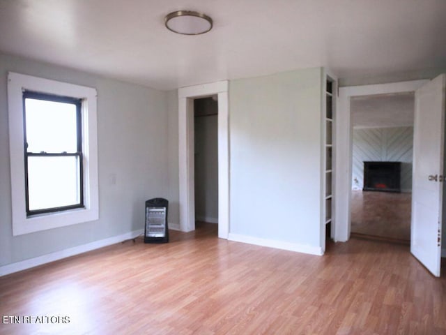 interior space with a tiled fireplace and hardwood / wood-style floors