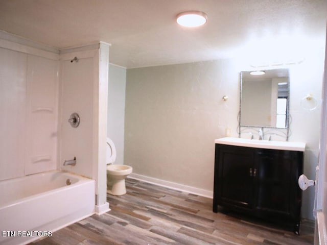 full bathroom with vanity, wood-type flooring, shower / bathtub combination, and toilet