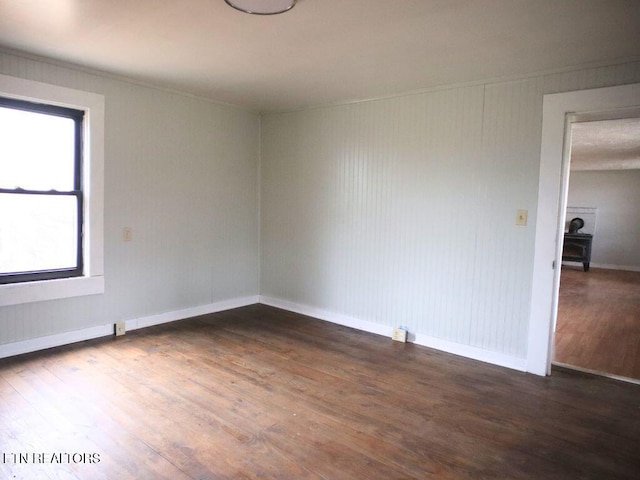 unfurnished room featuring dark wood-type flooring