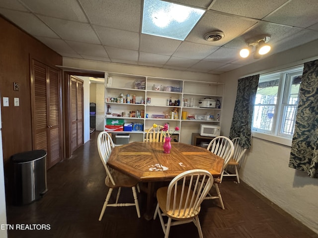 dining space featuring a paneled ceiling