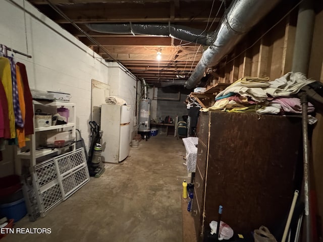 basement with water heater and fridge