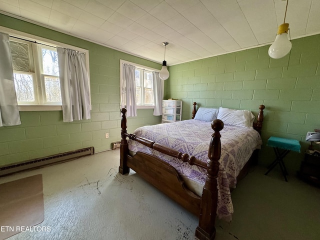 bedroom with baseboard heating and concrete floors