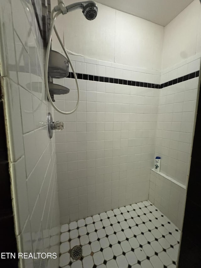 bathroom with a tile shower