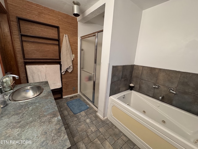 bathroom featuring shower with separate bathtub and sink