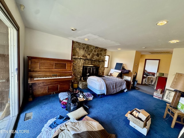 bedroom featuring carpet and a fireplace