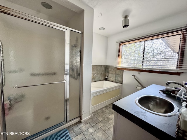 bathroom featuring vanity and separate shower and tub