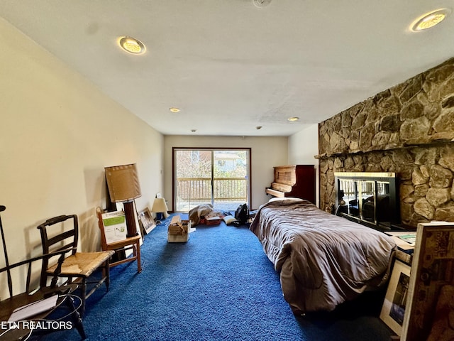 bedroom featuring carpet flooring, access to outside, and a fireplace