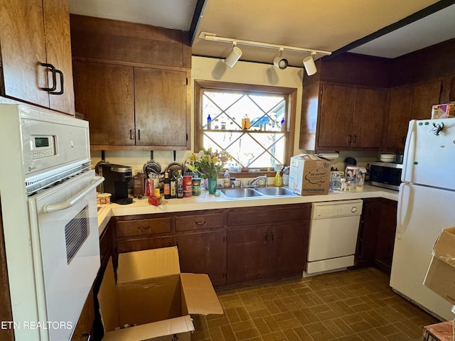 kitchen with sink and white appliances