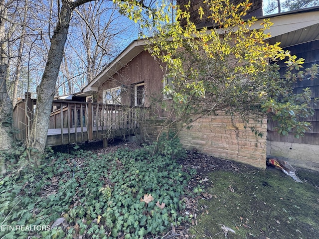 view of home's exterior with a wooden deck