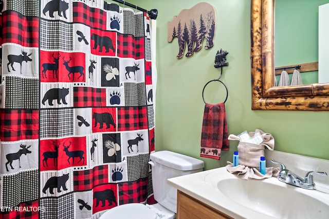 bathroom featuring vanity and toilet