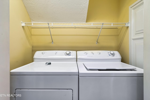 clothes washing area featuring independent washer and dryer