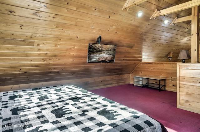 unfurnished bedroom with wooden ceiling, dark carpet, and wood walls