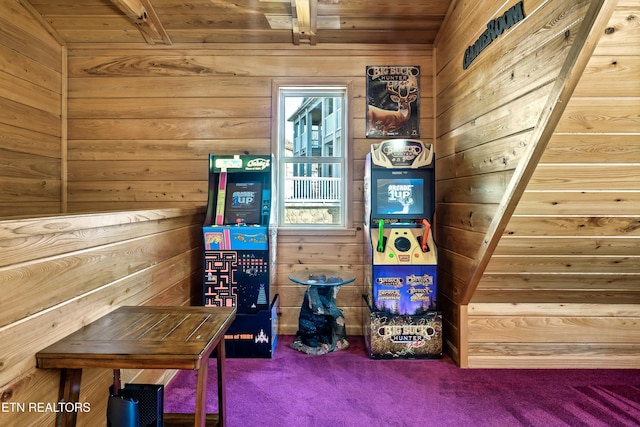 recreation room with wood ceiling, wooden walls, and carpet