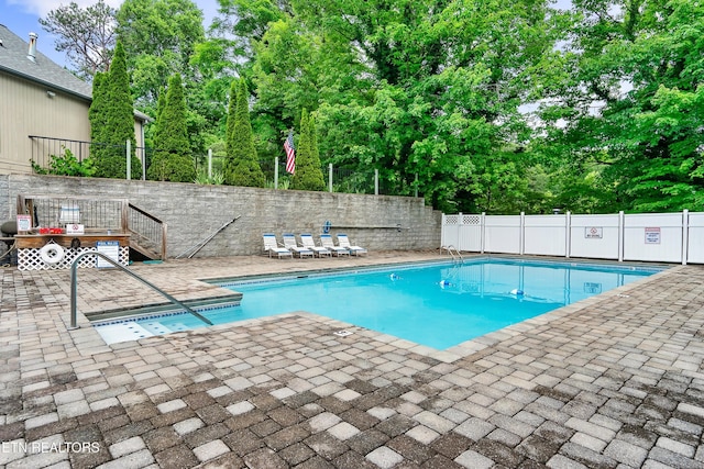 view of swimming pool featuring a patio area