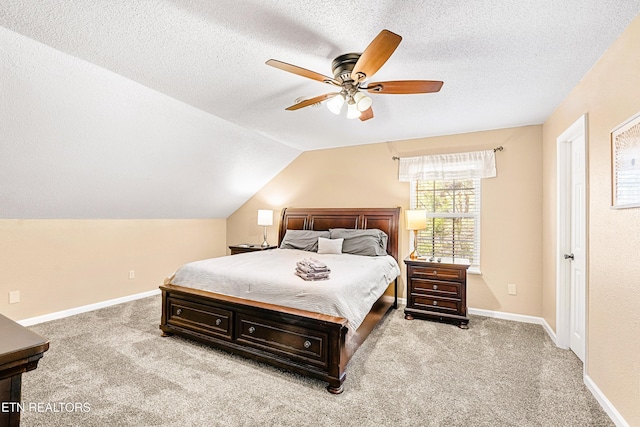 carpeted bedroom with ceiling fan, vaulted ceiling, and a textured ceiling