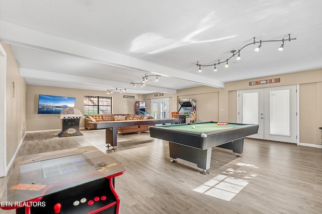 rec room with french doors, beam ceiling, pool table, a textured ceiling, and light hardwood / wood-style flooring