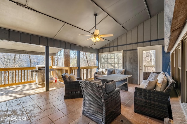 sunroom featuring lofted ceiling and ceiling fan