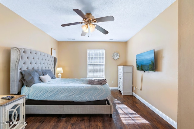 bedroom featuring ceiling fan, dark hardwood / wood-style floors, and a textured ceiling