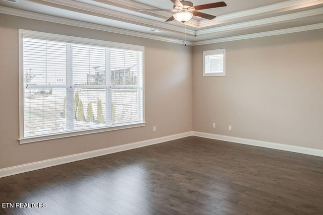 spare room with crown molding, a wealth of natural light, dark wood finished floors, and ceiling fan