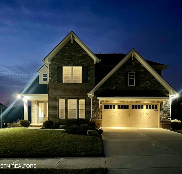 view of front of property featuring a yard, brick siding, and driveway