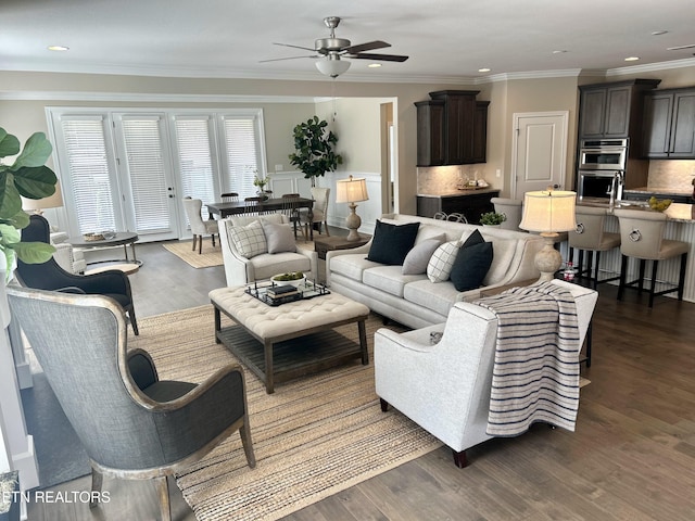 living room with ceiling fan, ornamental molding, wood finished floors, and recessed lighting