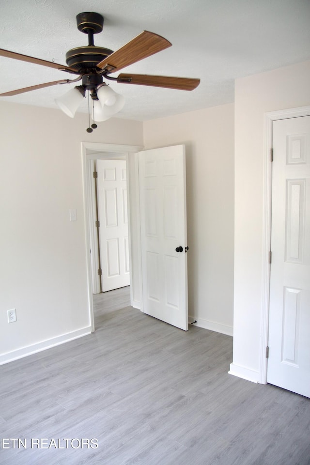 spare room featuring hardwood / wood-style floors and ceiling fan