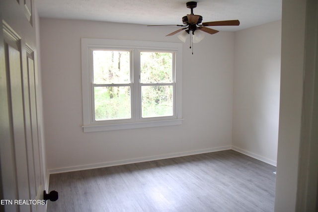 unfurnished room with hardwood / wood-style floors and ceiling fan