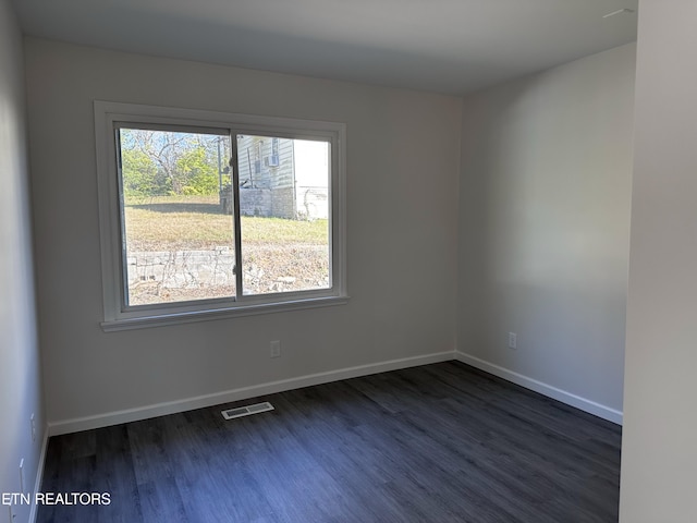 unfurnished room featuring dark hardwood / wood-style floors