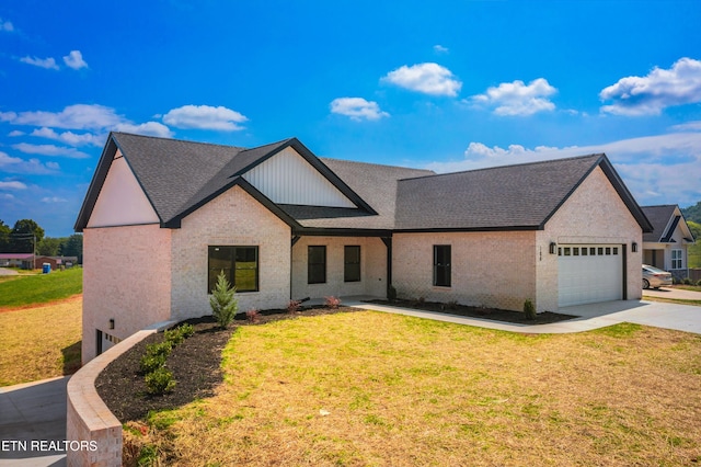 view of front of house with a garage and a front yard