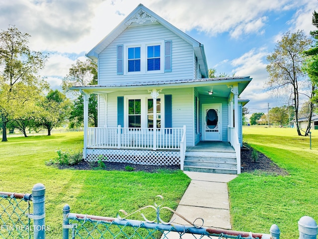 view of front facade featuring a front yard and covered porch