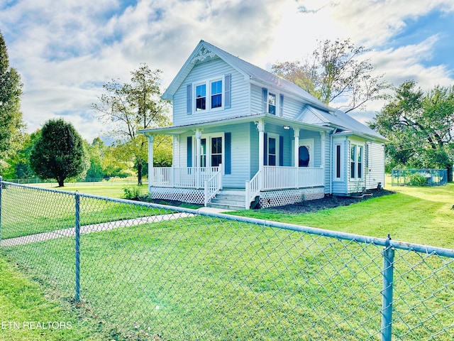 farmhouse-style home with a front lawn and covered porch