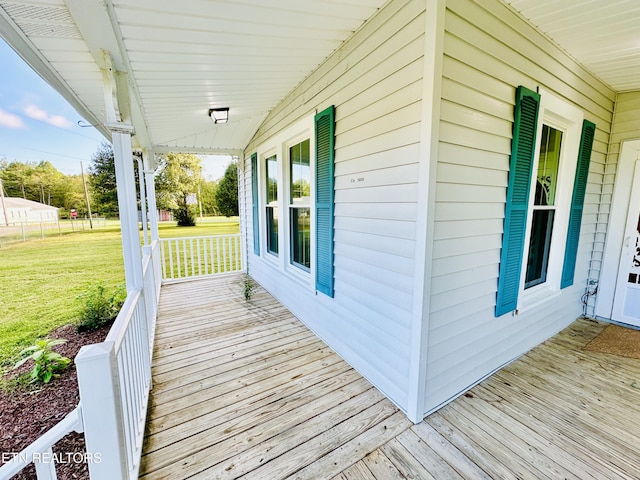 deck with a yard and covered porch