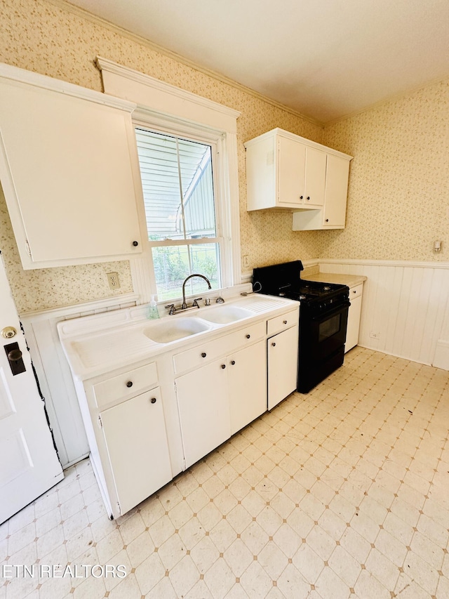 kitchen with white cabinetry, sink, and black gas range