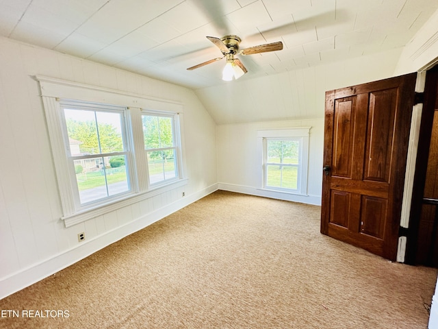 additional living space with lofted ceiling, light carpet, and ceiling fan