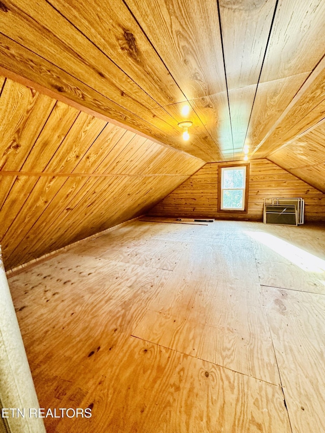 bonus room with wood ceiling, lofted ceiling, and wood walls