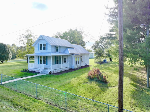 country-style home featuring a front yard and covered porch