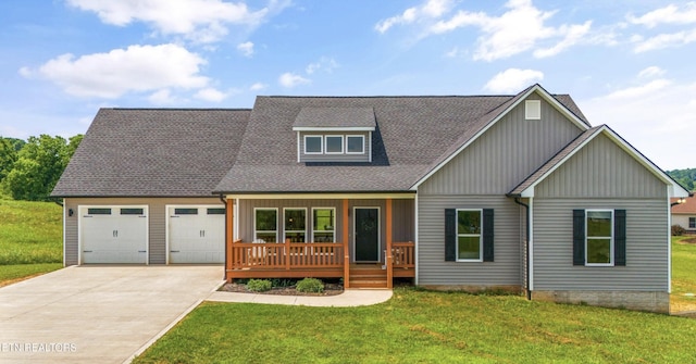 view of front of house with a wooden deck, a garage, and a front lawn