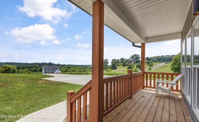 deck with a porch and a yard