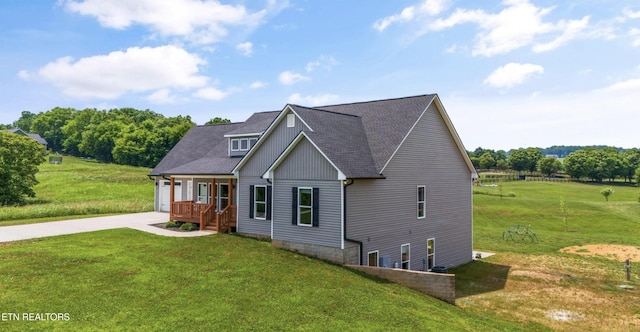 view of front of house with a garage, a front yard, and a porch