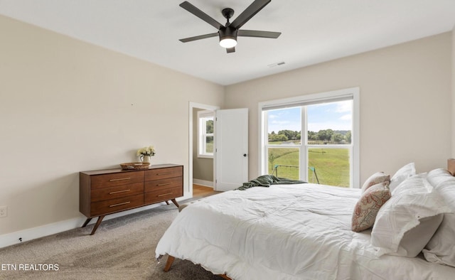 bedroom with light colored carpet and ceiling fan