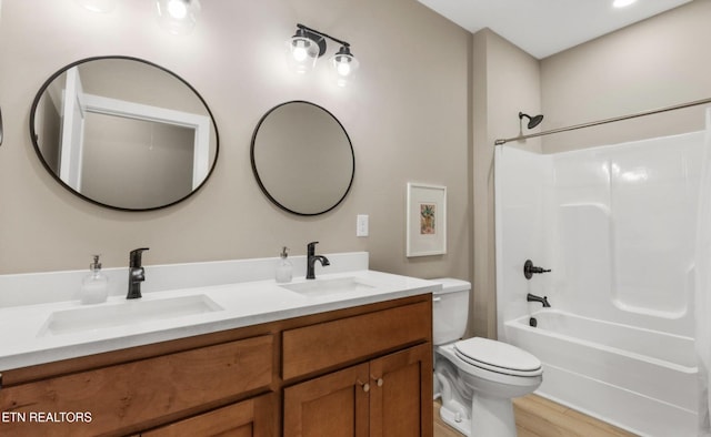 full bathroom featuring vanity, wood-type flooring, tub / shower combination, and toilet