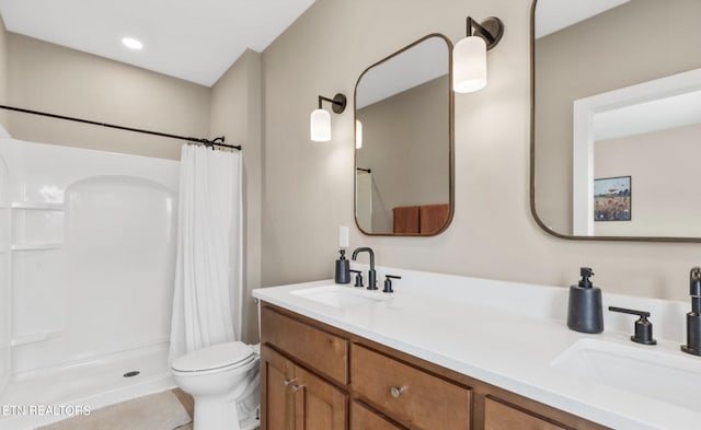 bathroom with vanity, toilet, and walk in shower