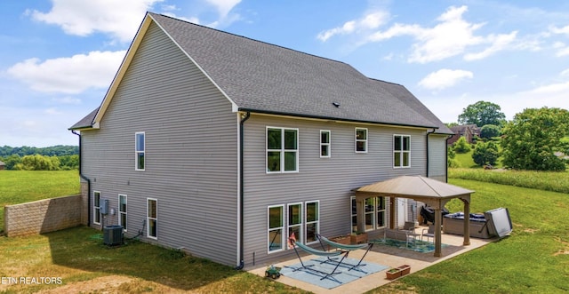 back of property with a gazebo, a yard, a hot tub, and a patio area