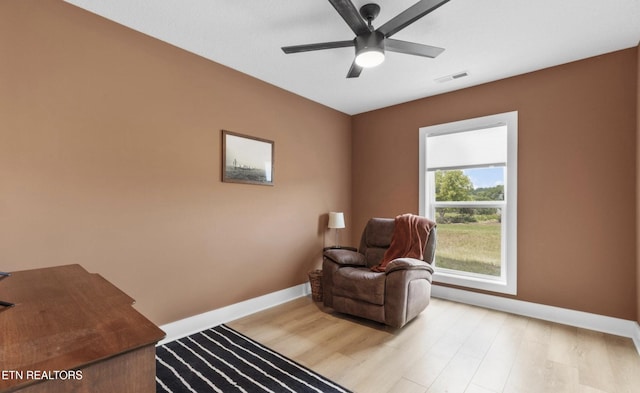 sitting room with light hardwood / wood-style floors and ceiling fan