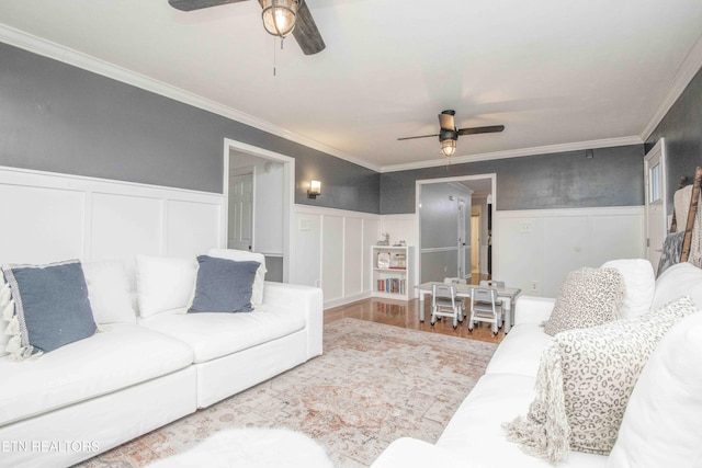 living room with ceiling fan, ornamental molding, and hardwood / wood-style floors