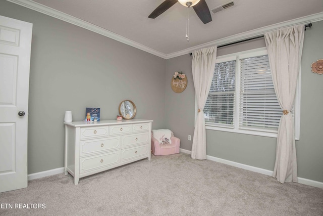 carpeted bedroom featuring crown molding and ceiling fan