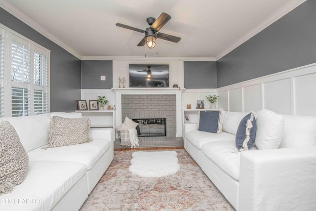 living room featuring ceiling fan, ornamental molding, and a fireplace