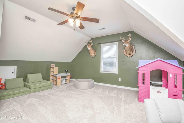 game room with vaulted ceiling, light carpet, and ceiling fan